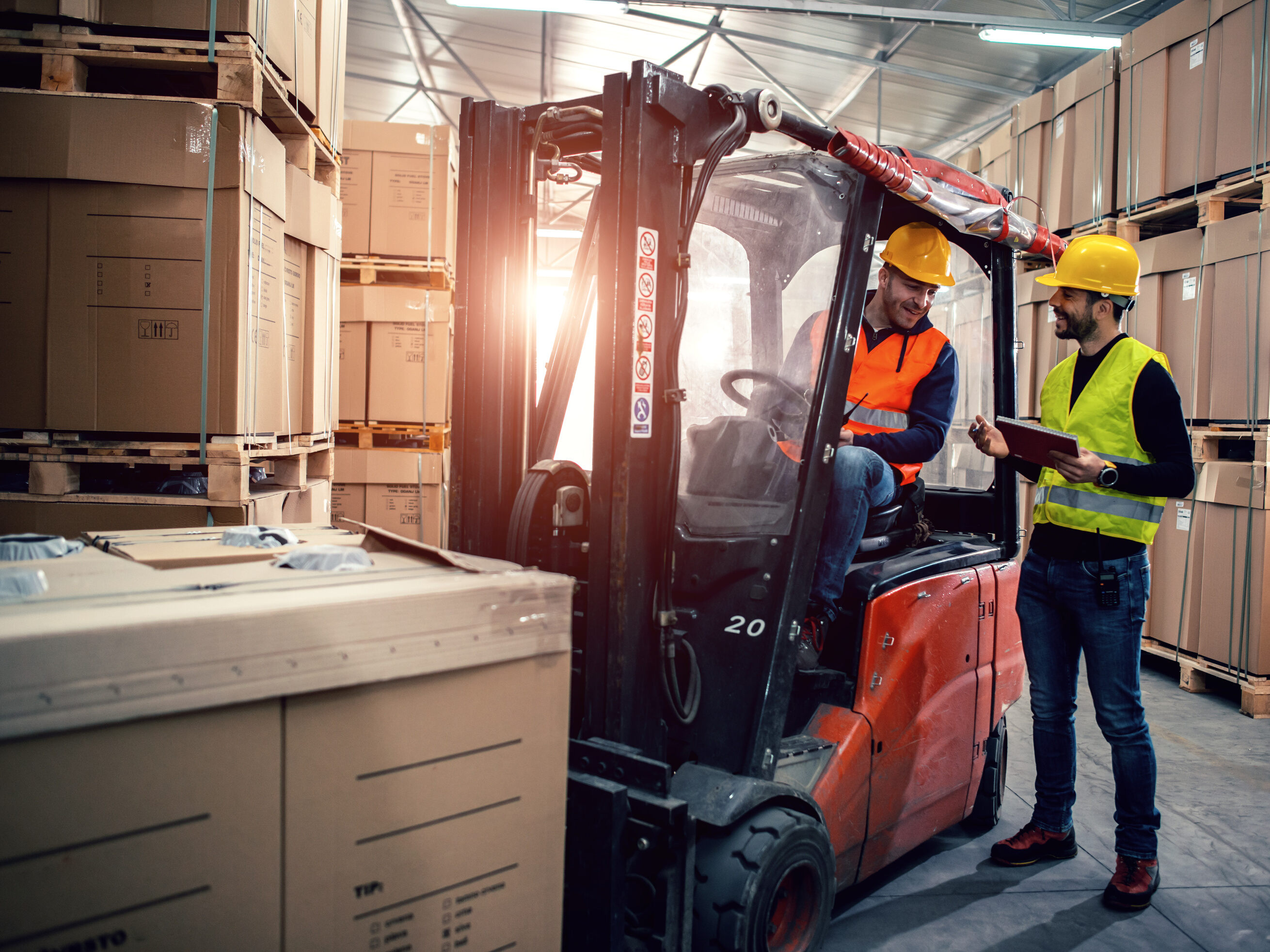Workers in warehouse with forklift